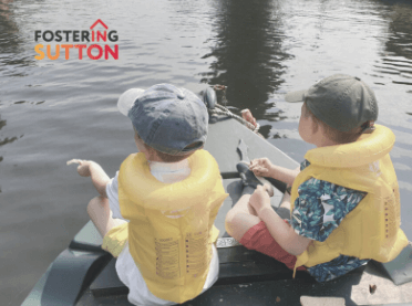 Two children floating on a canoe