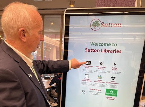 Leader of the Council, Barry Lewis using the new interactive screen at Sutton Library